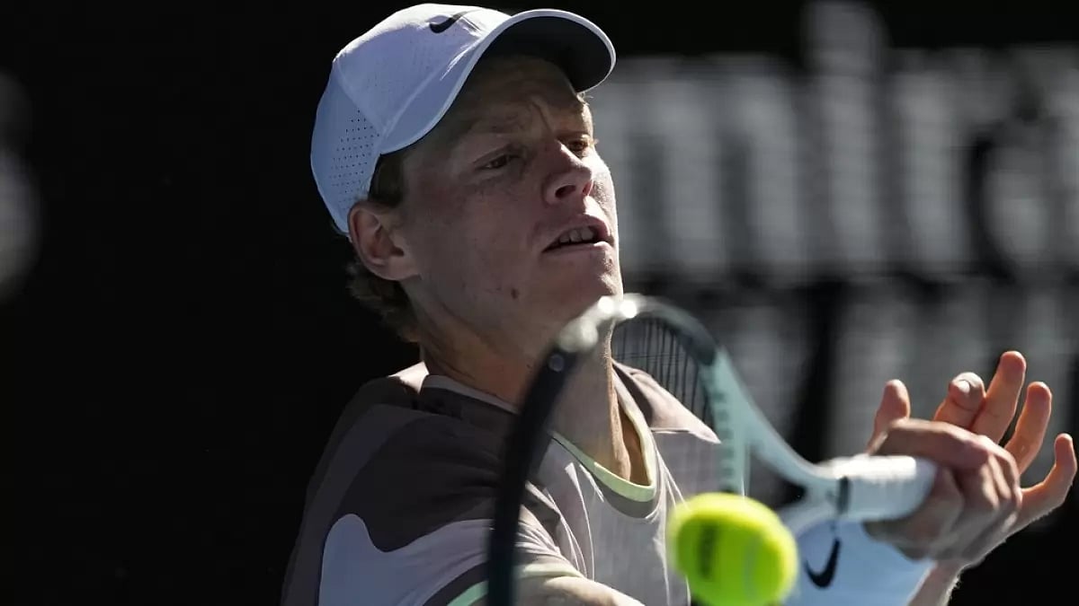 AP : Jannik Sinner hits a return to Novak Djokovic during their men's singles semi-final match at the Australian Open 2024