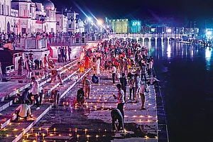 Photo: PTI : Illuminated Devotees light lamps at Ramghat in Ayodhya