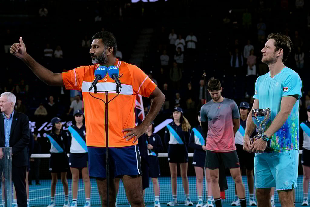 Rohan Bopanna, left, of India and Matthew Ebden of Australia react after receiving their trophy after defeating Simone Bolelli and Andrea Vavassori of Italy in the men's doubles final at the Australian Open tennis championships at Melbourne Park, Melbourne, Australia, Saturday, Jan. 27, 2024. -  (AP Photo/Andy Wong)   