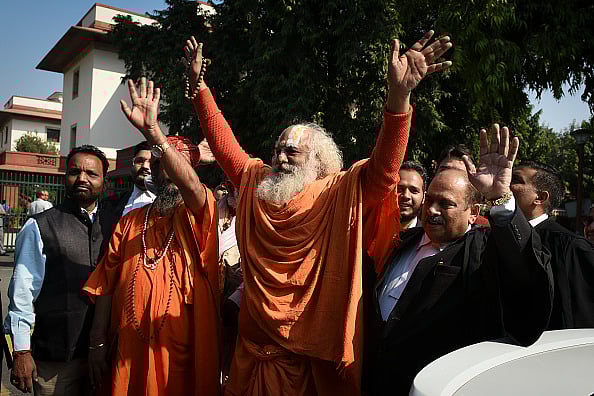 Getty Images : Sadhu Sants and VHP workers shout slogans as they leave for Ayodhya 84 Kosi Parikrama Yatra from Krishna Temple Udasin Ashram near Rajghat Power House in New Delhi.
