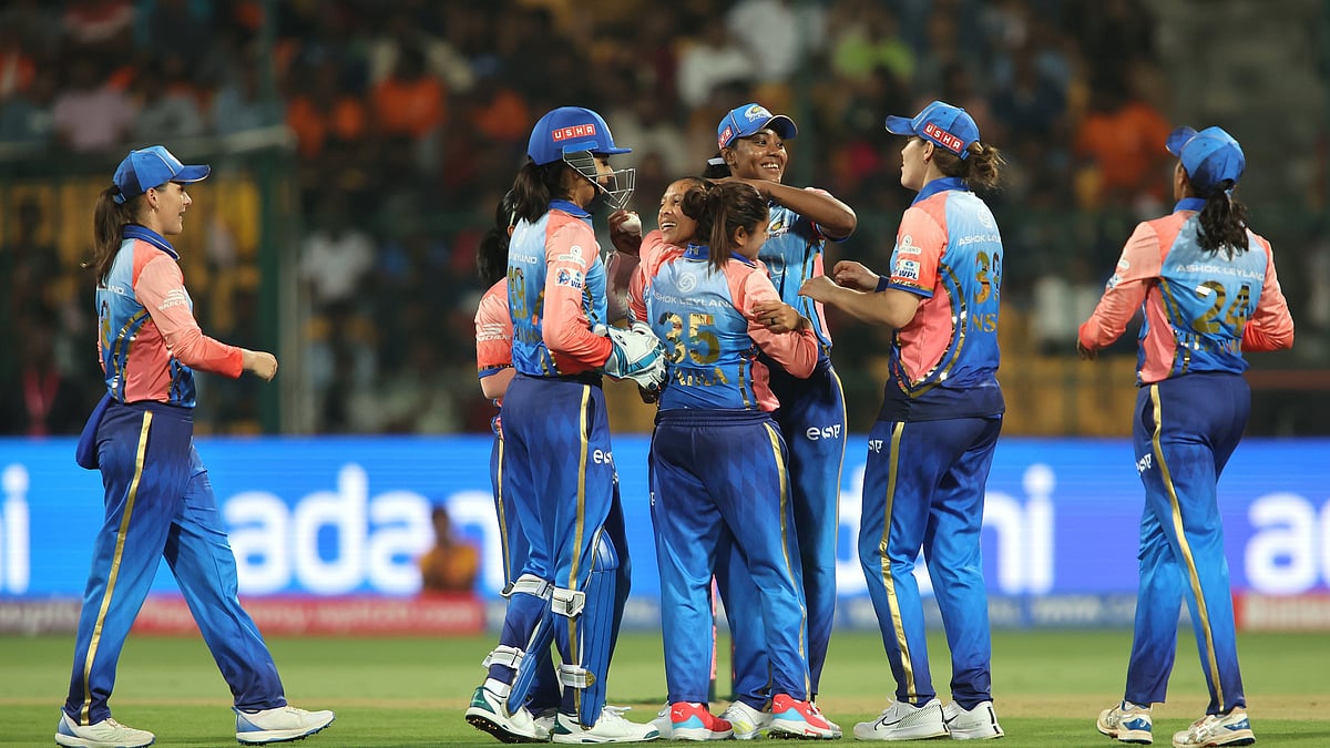 (Photo: X/ @wplt20) : Mumbai Indians players celebrating after taking the wicket of Gujarat Giants' Phoebe Litchfield. 