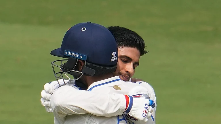 India's Shubman Gill celebrates his century with India's Axar Patel, in the helmet, on the third day of the second test match between India and England, in Visakhapatnam, India, Sunday, Feb. 4, 2024.
- (AP Photo/Manish Swarup)