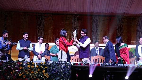 Khelo India : International boxer Jamuna Boro handing over the Khelo India University Games 2023 torch to Union Minister for Sports and Youth Affairs Shri Anurag Singh Thakur at the Sarusajai Sports Complex in Guwahati on Monday. 