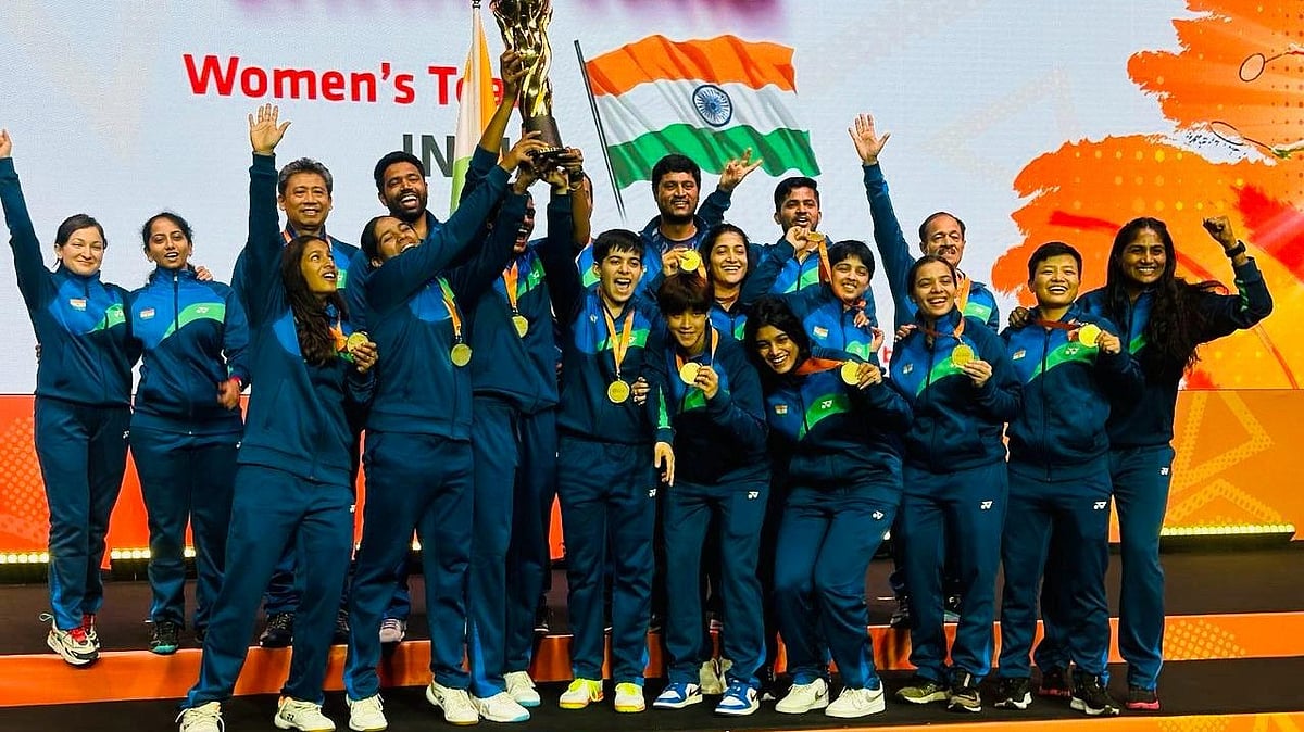 BAI : India women's badminton team pose with the trophy.