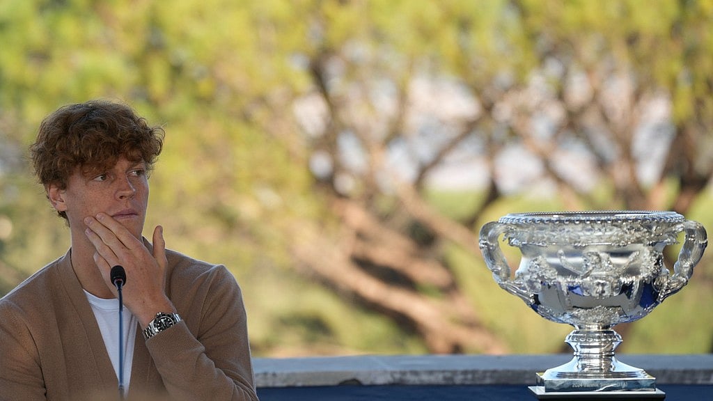 AP Photo/Gregorio Borgia : Italian tennis player Jannik Sinner speaks in front of the Australian Open trophy in Rome.