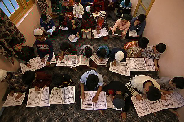 Getty Images : Students attend Quran classes at a madrassa (Islamic seminary) before breaking the fast in the holy month of Ramadan in Srinagar on April 30, 2022. |