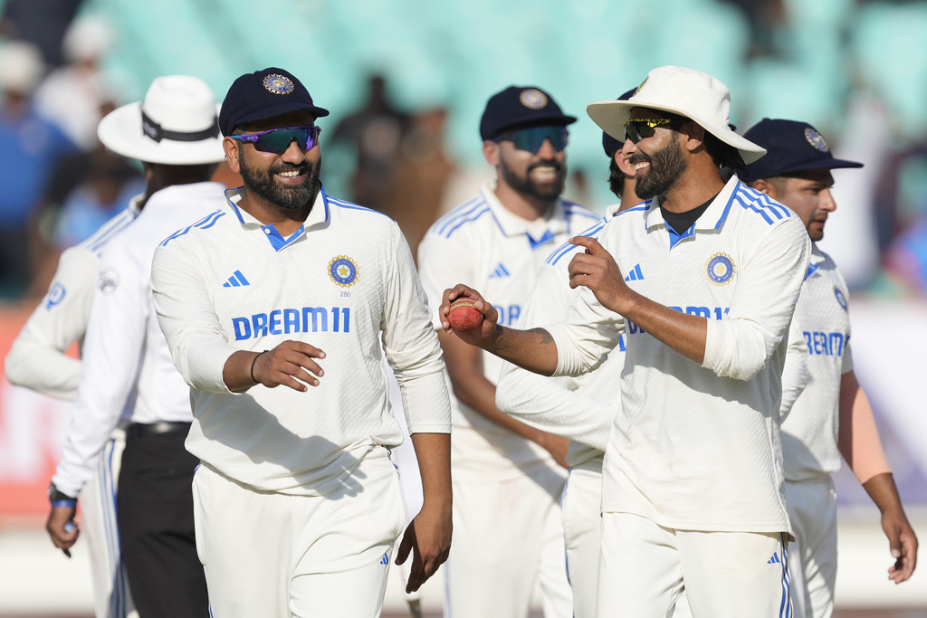 India's captain Rohit Sharma, left, and teammate Ravindra Jadeja celebrate after India won the third cricket test match against England in Rajkot, India, Sunday, Feb. 18, 2024.