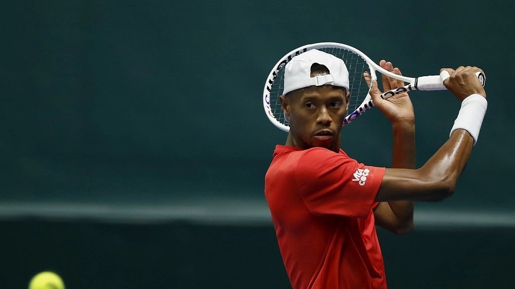 (AP Photo/Mindaugas Kulbis) : Christopher Eubanks of the USA in action during the Davis Cup qualifying tennis match playing against Ukraine's  Viacheslav Bieliskyi in Vilnius, Lithuania, Thursday, Feb. 1, 2024. 
