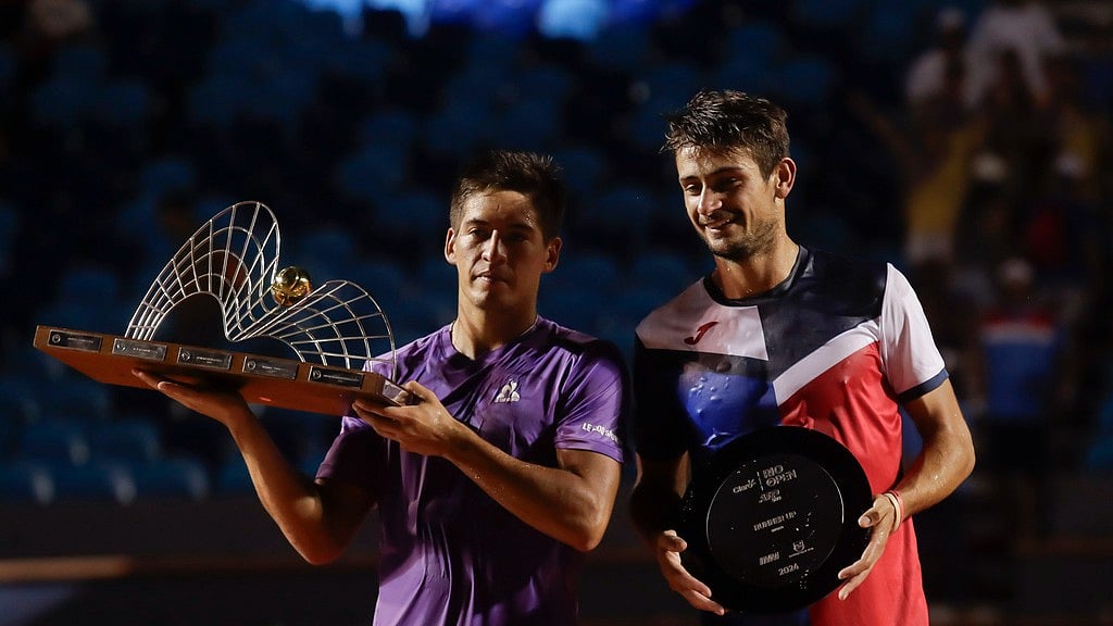 AP : Sebastian Baez and Mariano Navone, both of Argentina, pose with their trophies after the final match of the Rio Open tennis tournament in Rio de Janeiro, Brazil, February 25, 2024.