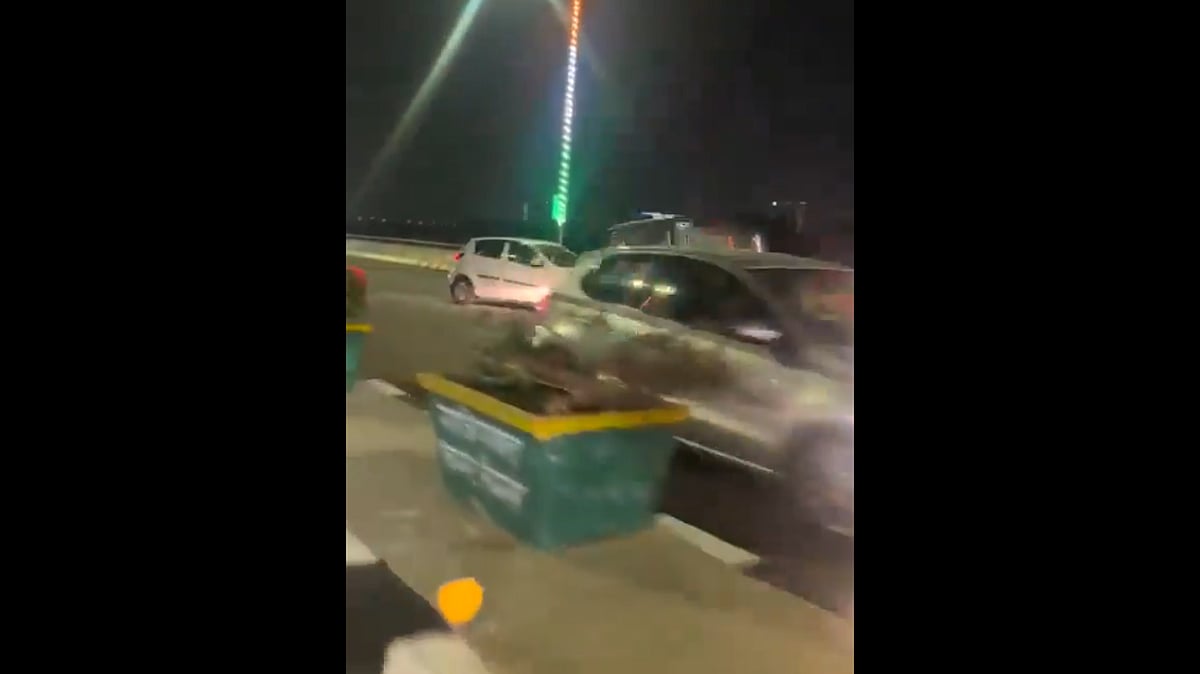 Twitter : A viral video unfolds a daring scene on Ghaziabad's elevated road as a car executes a reverse stunt.