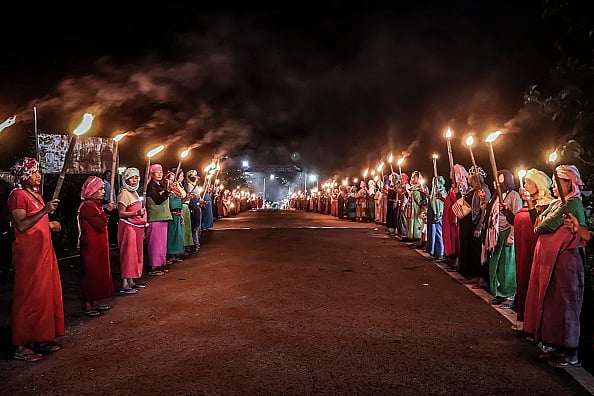 Getty Images : Women belonging to the 'Meira Paibis', a group of women representing Meitei society, hold torches during a demonstration demanding for the restoration of peace in Manipur |
