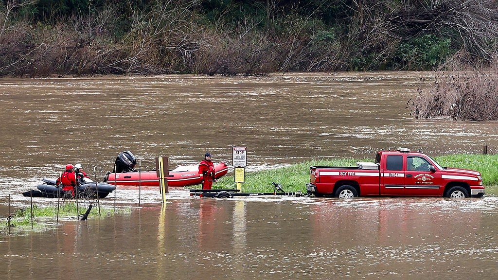 Image: AP : Sonoma County Firefighters load up their boats after patrolling the waters of the Russian River as it swells with twenty feet of water at action stage near Guerneville.