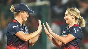Photo: X/ @RCBTweets : RCB-W's Sophie Devine (L) and Sophie Molineux celebrating after taking a wicket against Gujarat Giants in WPL 2024.