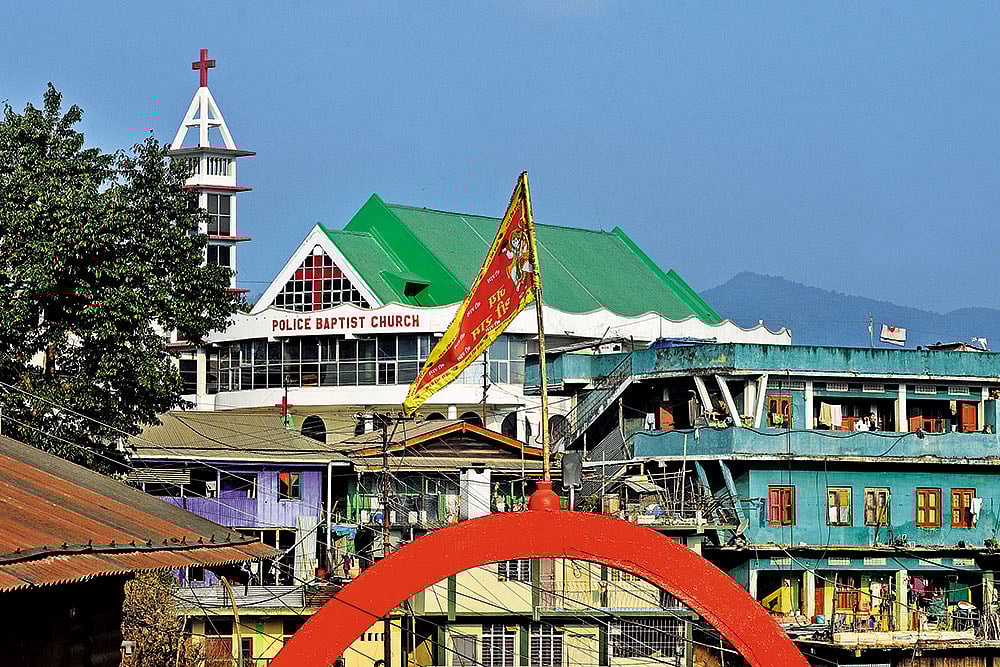 Photo: Sandipan Chatterjee : Making Inroads: A church overlooks a temple in Tuensang, eastern Nagaland
