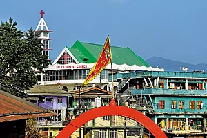Photo: Sandipan Chatterjee : Making Inroads: A church overlooks a temple in Tuensang, eastern Nagaland