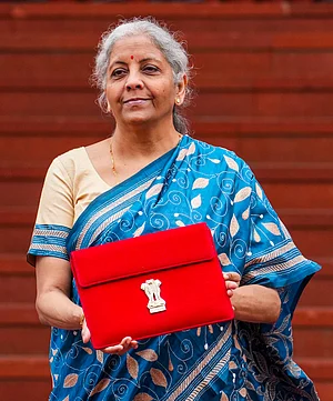 PTI : Finance Minister Nirmala Sitharaman upholds her digital tradition by presenting a paperless Budget, carrying a tablet in a traditional 'bahi-khata' style pouch as she heads to Parliament.