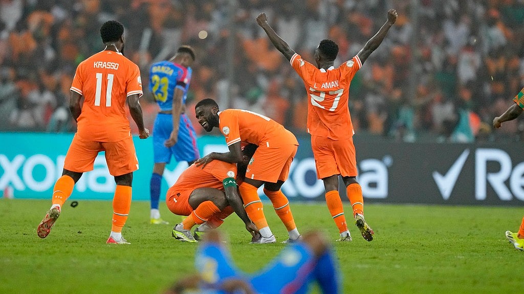 (AP Photo/Sunday Alamba) : Ivory Coast players, top center, celebrate after winning the African Cup of Nations semifinal against DR Congo.