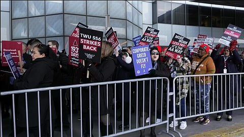 Flight attendants picketed outside airports to protest on Tuesday.A