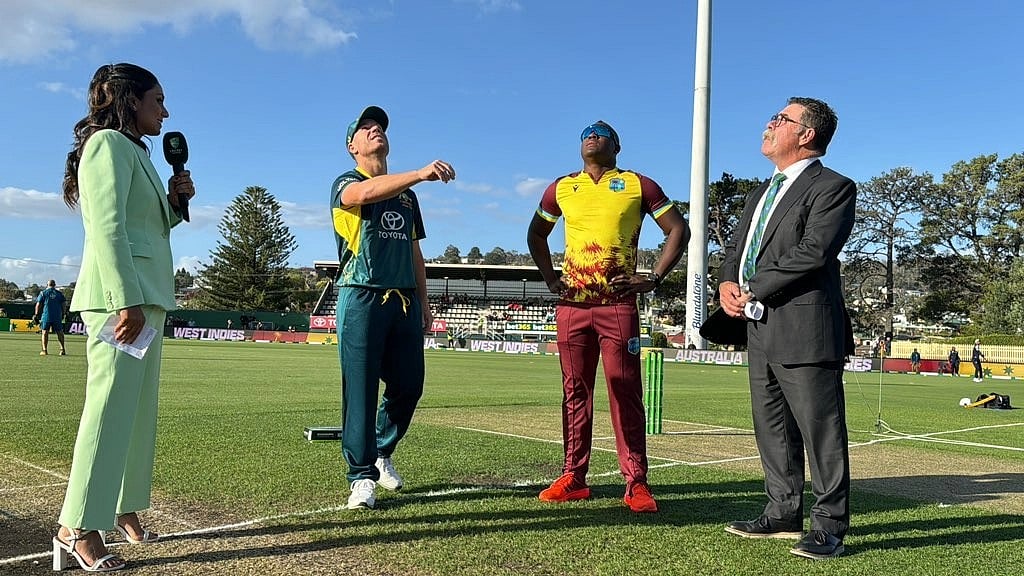 Stand-in Australia captain David Warner at the toss alongside West Indies' Rovman Powell for the first T20I in Hobart.   - X/Windies Cricket