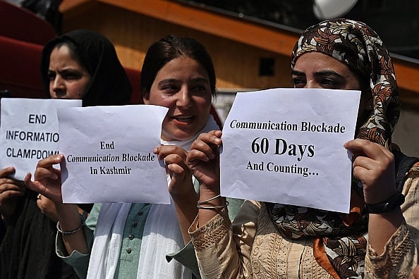 Journalists hold signs during a protest against the restrictions of the internet and mobile phone networks at the Kashmir Press Club during a lockdown in Srinagar on October 3, 2019.  - Getty Images