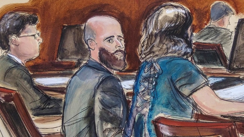 In this courtroom sketch, Joshua Schulte, center, is seated at the defense table flanked by his attorneys during jury deliberations, March 4, 2020, in New York. - Image: AP