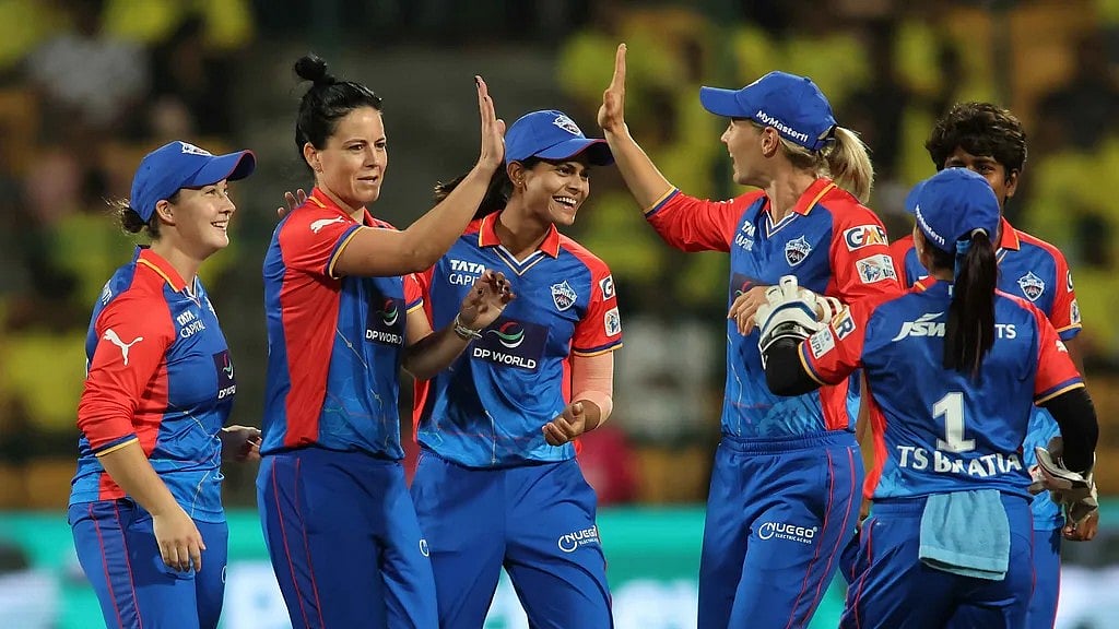 Delhi Capitals' Marizanne Kapp celebrates a wicket with teammates during their Women's Premier League 2024 clash against the Gujarat Giants at the M Chinnaswamy Stadium on February 26. - null