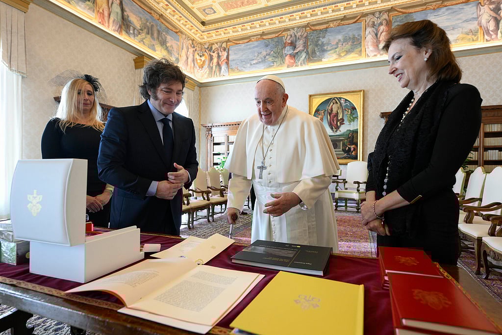 AP : Argentine President Javier Milei, second from left, his sister and Secretary-General of the Presidency Karina Milei, left, and Foreign Minister Diana Mondino, right, exchange gifts with Pope Francis as they arrive in the pontiff's studio at The Vatican for a private audience.