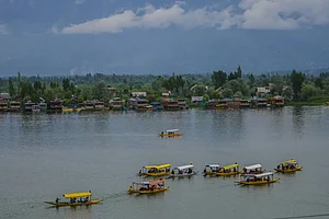 AP : Tourusts enjoy boat ride at Dal Lake in Srinagar.