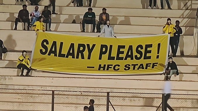 Photo - X/IFTWC : Employees unfurl the banner at the stadium.