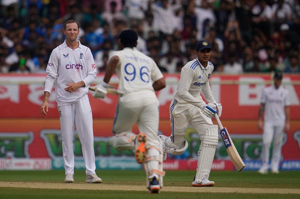 Tom Hartley reacts as India's Shreyas Iyer and Shubman Gill run between the wickets on the third day of the second cricket Test match between India and England in Visakhapatnam. - AP Photo/Manish Swarup