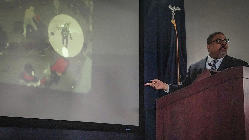 | Image: AP : District Attorney Alvin Bragg explain an evidence video during a press conference where he announced charges for migrants involved in a Times Square brawl with police.