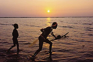 Photo: Getty Images : In Isolation: Jarawas fishing 
on a coral reef