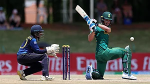 (Photo: ICC) : Riley Norton of South Africa plays a shot as Wicketkeeper Sharujan Shanmuganathan of Sri Lanka looks on during the ICC U19 Men's Cricket World Cup South Africa 2024 Super Six match between South Africa and Sri Lanka at JB Marks Oval on February 02, 2024.
