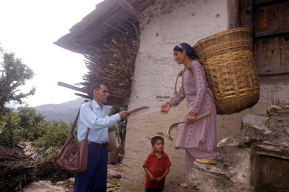 A postman delivering a letter in Dehradun, Uttarakhand. - Getty Images