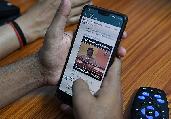 Getty Images : The photo shows an Aam Aadmi Party (AAP) volunteer for the social media team working on a mobile phone in the 'war room' ahead of the 2019 national elections at the party headquarters in New Delhi.