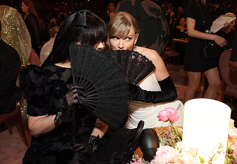 Taylor Swift Hides Face With A Large Fan