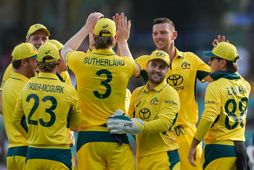 Photo: AP/Rick Rycroft : Australia's Josh Hazlewood, second right, and Will Sutherland, centre, celebrate after combining to take the wicket of the West Indies' Justin Greaves during their one-day international cricket match in Sydney.