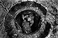My Life As A Protest Photo: Sudharak Olwe : A life of indignity—A manual scavenger removing excreta from a dry pit