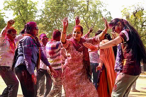 Police personnel celebrate Holi
