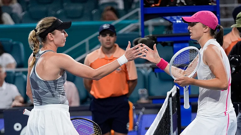 Iga Swiatek, of Poland right, and Ekaterina Alexandrova, of Russia, congratulate each other after their Miami Open match on March 25, 2024, in Miami Gardens, Fla. - AP