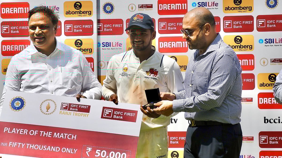 (Photo: X|Mumbai Cricket Association)  : Mumbai's Musheer Khan receives his POTM from BCCI's Honorary Treasurer, Ashish Shelar, alongside MCA President, Amol Kale for his remarkable performance in the final match of Ranji Trophy 2024 against Vidarbha. 