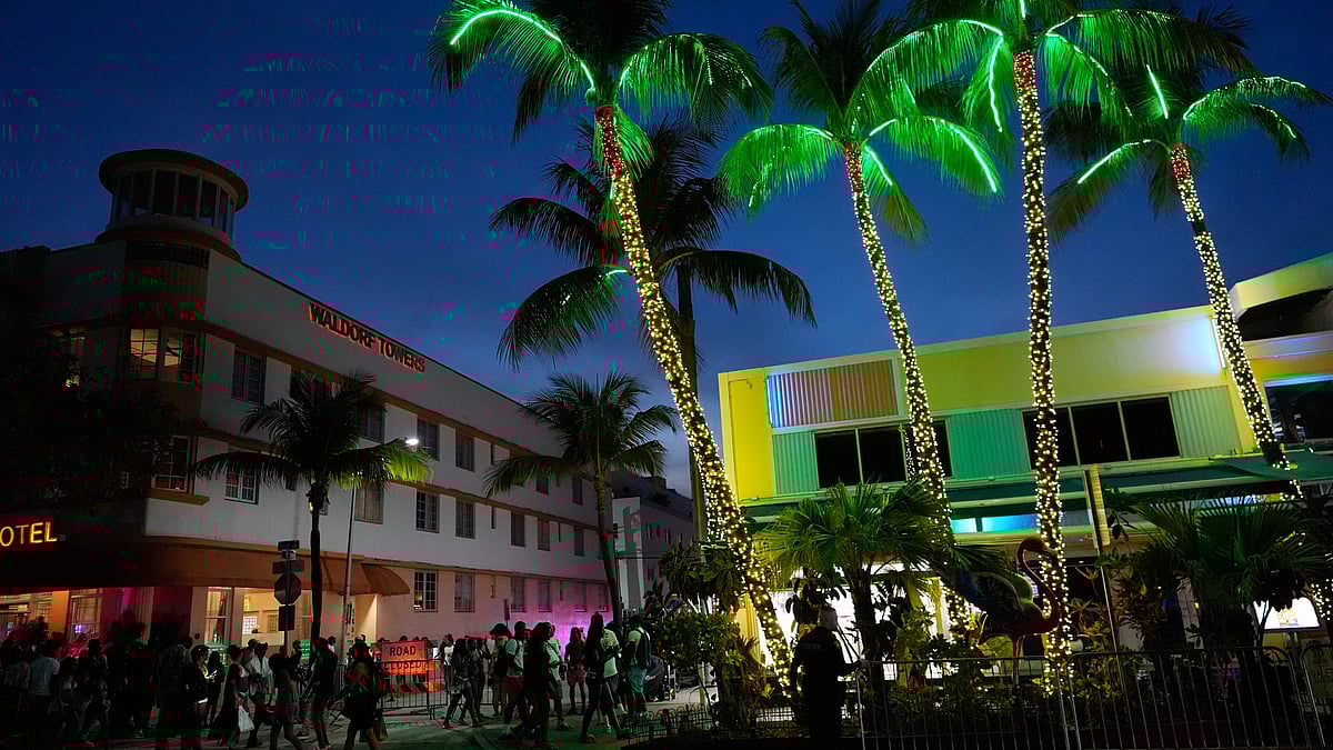 AP : People stroll along Ocean Drive as they enjoy spring break on South Beach.
