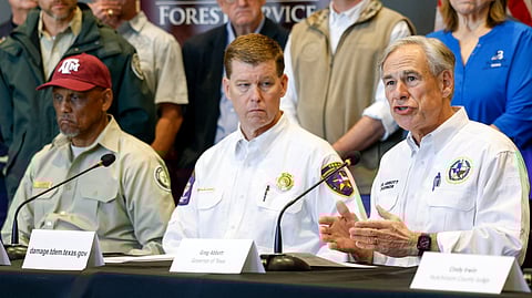 Texas Gov. Greg Abbott, right, speaks during a news conference about the panhandle wildfires next to Al Davis, Texas A&M Forest Service director.