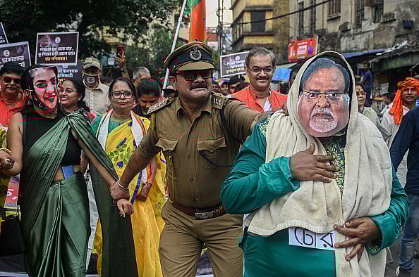Getty Images : Activists of India's ruling Bharatiya Janata Party (BJP), dressed as former education minister of West Bengal, Partha Chatterjee