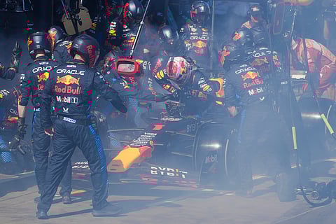 Mechanics work to extinguish a fire in Red Bull driver Max Verstappen of the Netherlands' car during the Australian Formula One Grand Prix at Albert Park, in Melbourne, Australia, Sunday, March 24, 2024.
