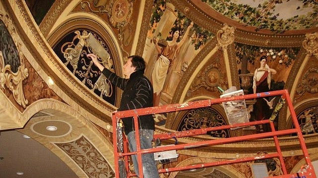 Andrew Zabela-Zabelin paints a wall mural, location and date not specified. - St. George News