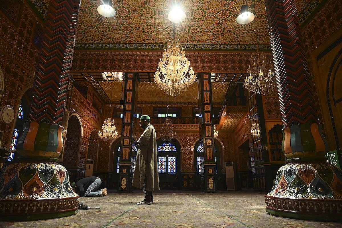 A man praying in a mosque.