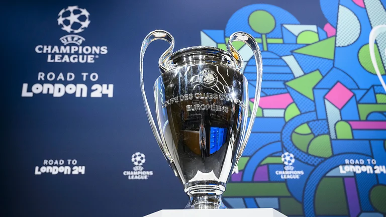 The Champions League trophy is pictured during the quarter-final draw of the UEFA Champions League 2023/24. - Jean-Christophe Bott/Keystone via AP