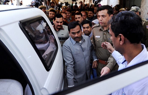 Getty Images : India's former telecom minister A. Raja (C), escorted by Central Bureau of Investigation (CBI) official and police, walks out of the court in New Delhi on February 3, 2011