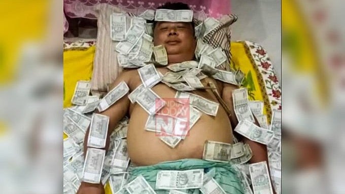 X/@Krasnyyyyy : Assamese politician Benjamin Basumatary's image of sleeping on a pile of notes made rounds on Internet |